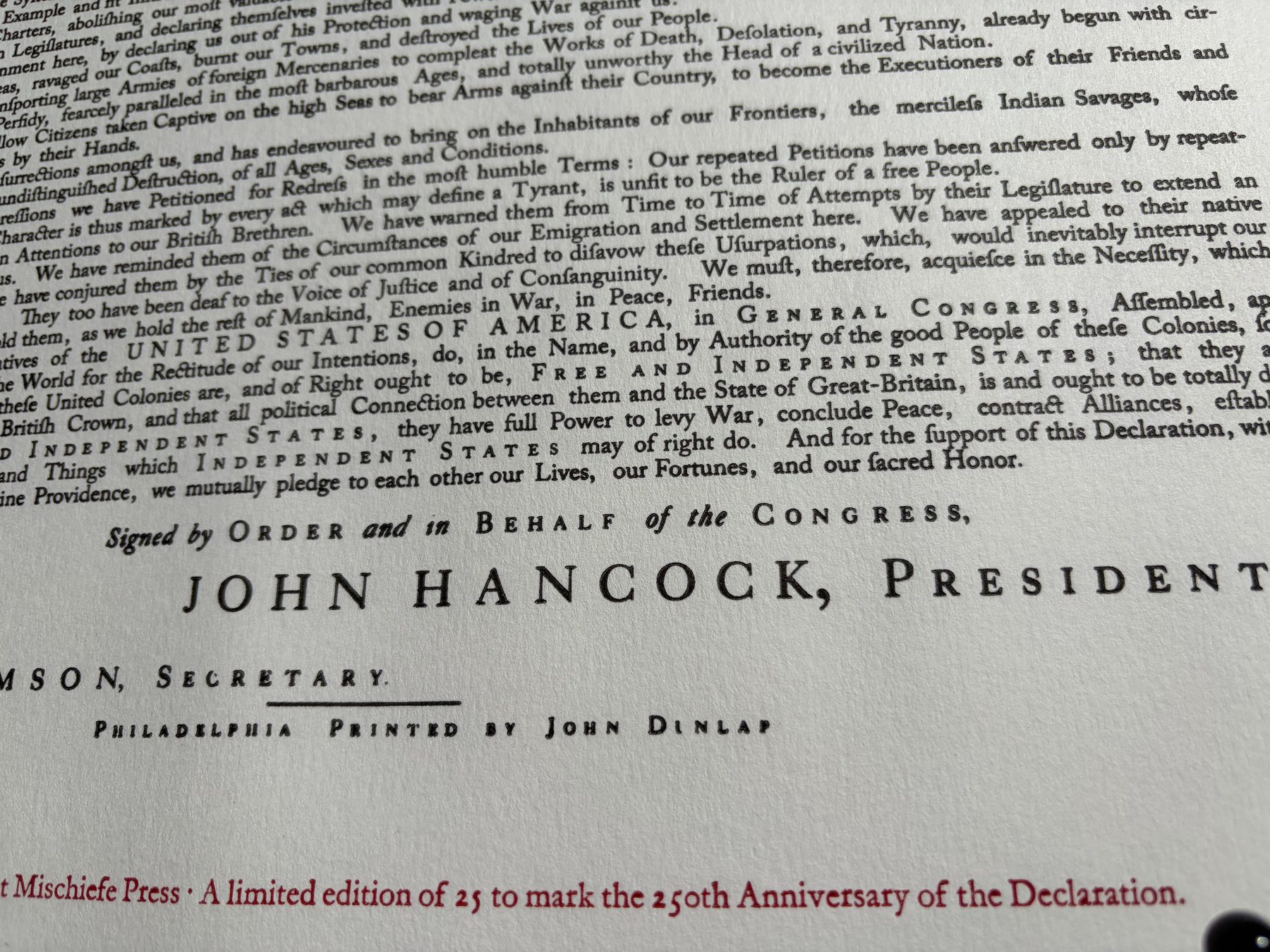 Detail of the printed Declaration showing John Hancock’s name and the red 250th-anniversary colophon
